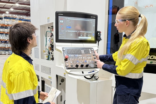Man and woman operating a machine computer